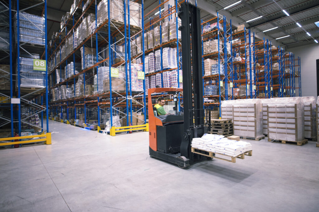 Worker operating forklift in a busy 3PL warehouse at efillship, efficiently managing ecommerce inventory